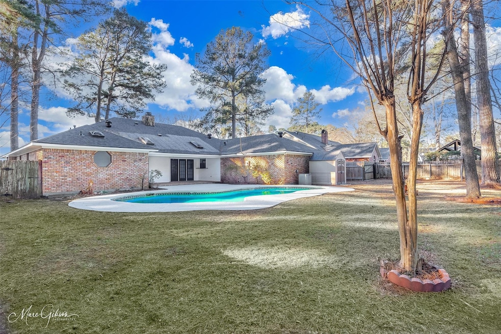 Back of property featuring a fenced in pool, a pat