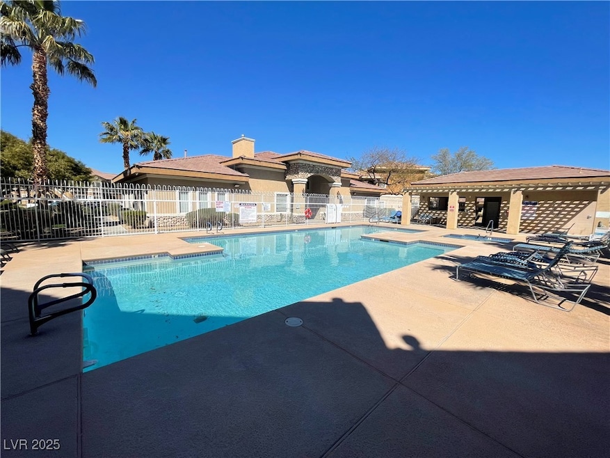 Community pool featuring a patio, fence, and a hot