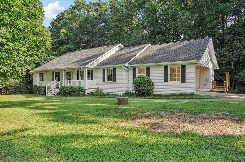 Single story home with covered porch and a shingled roof