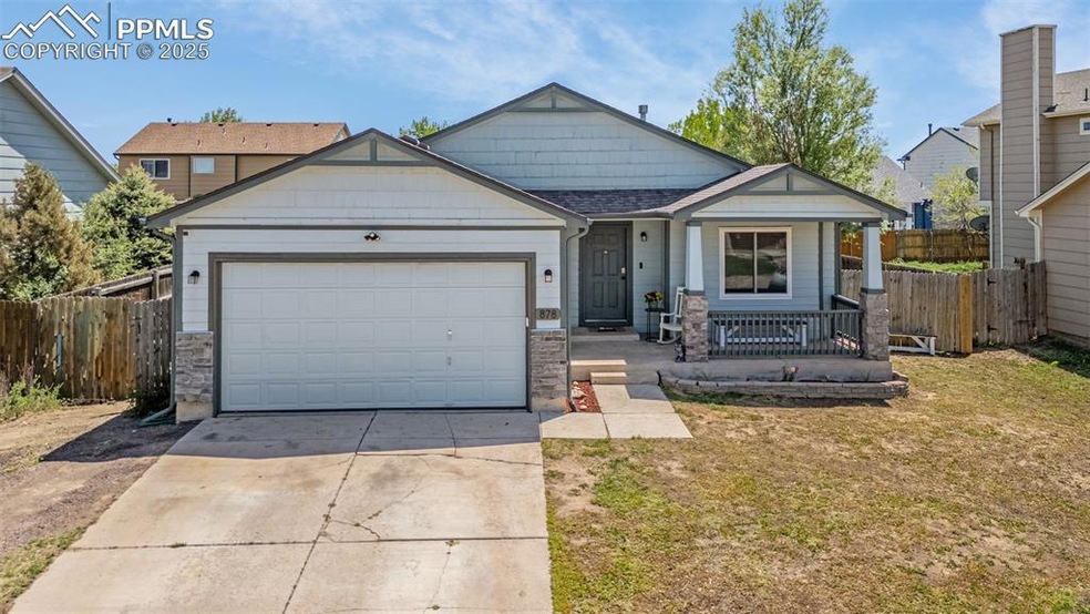 View of front of property featuring covered porch, concrete driveway, and an attached garage