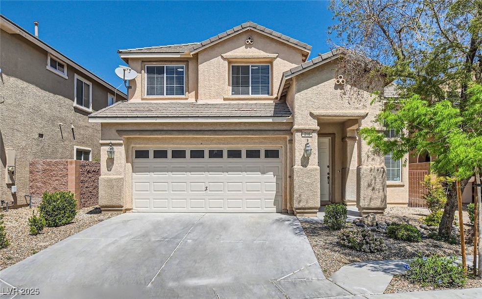 View of front of home featuring driveway, a garage