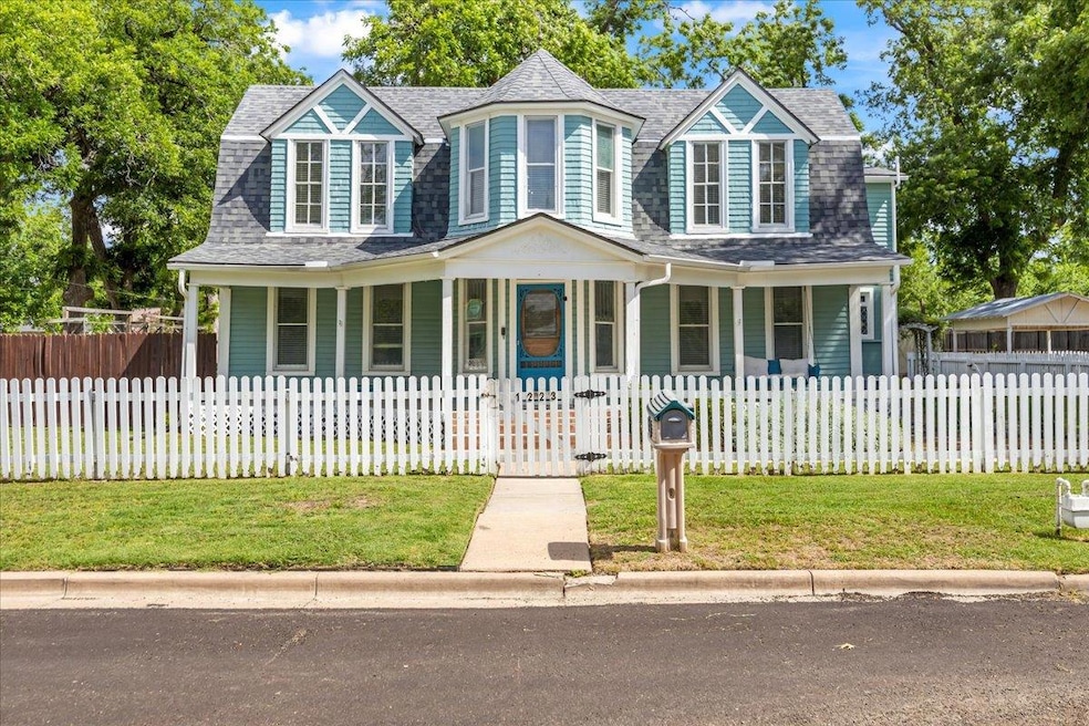 View of front of property with a porch and a shin