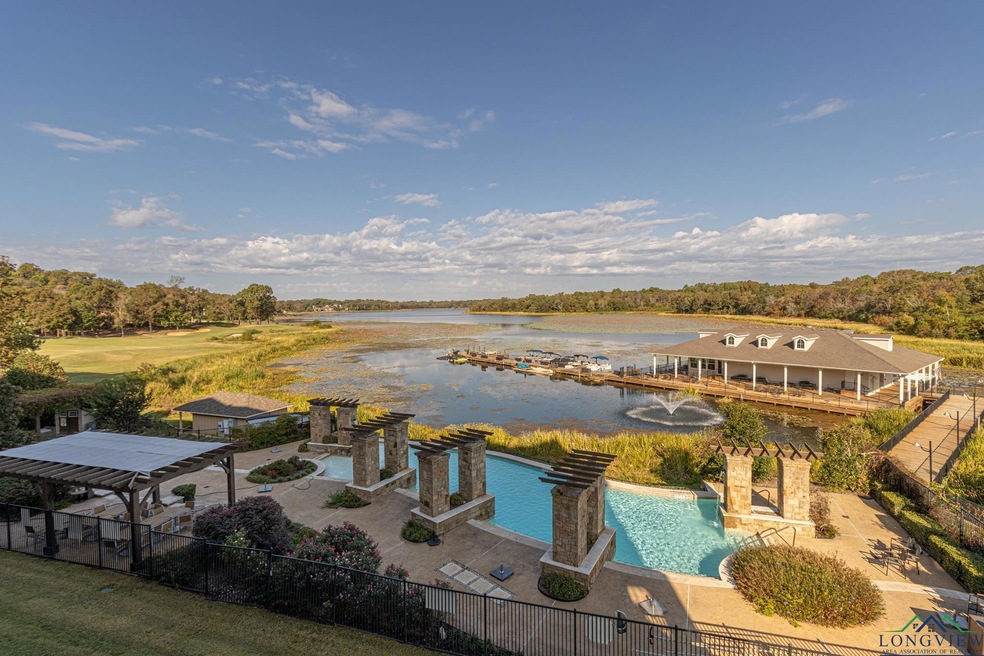 View of pool featuring a patio and a water view