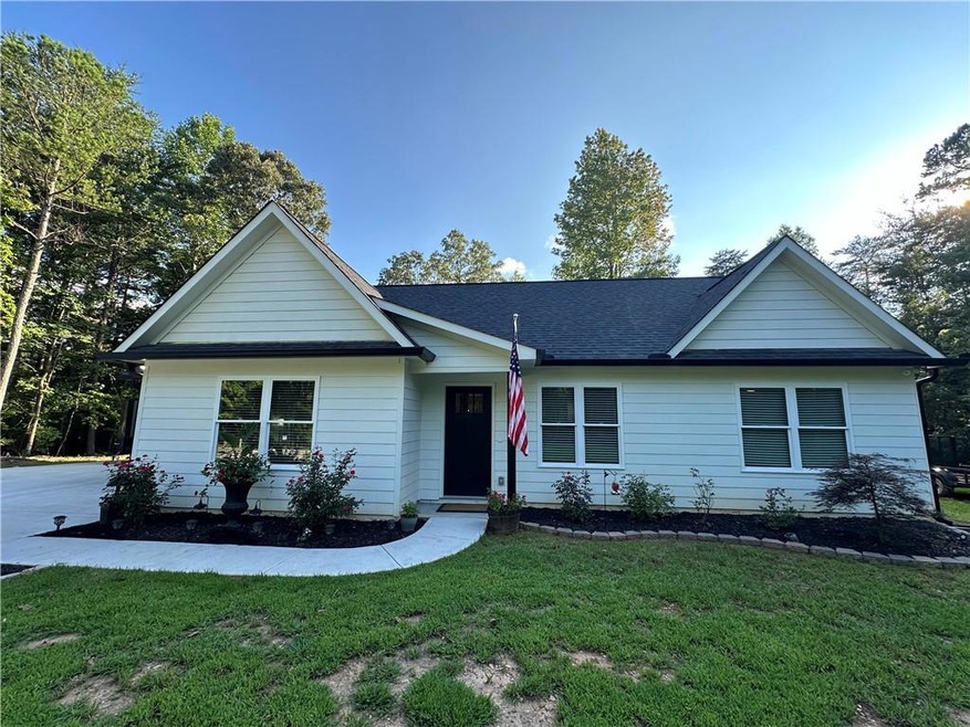 Single story home featuring a front lawn