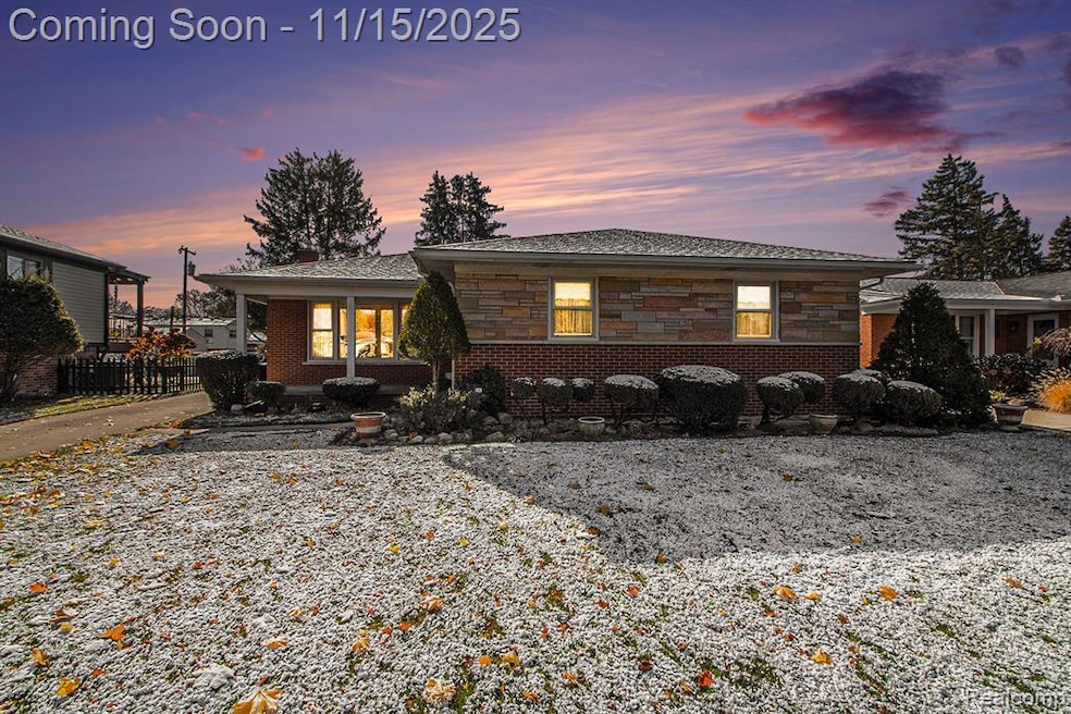 View of front facade with stone siding, covered porch, and brick siding