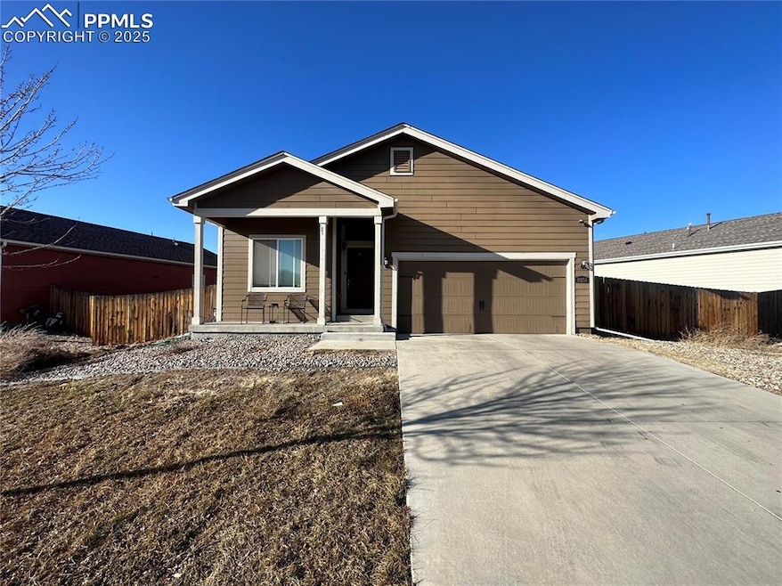 View of front facade with covered porch, fence, a 
