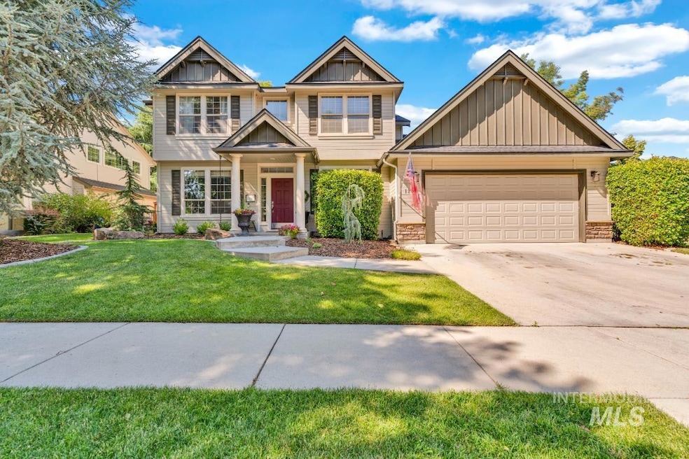 Craftsman house with board and batten siding, an attached garage, driveway, and a front yard