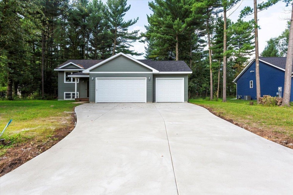 Front view with new concrete driveway ~ Wooded lot