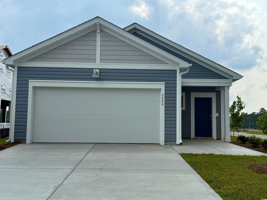 View of front of property with concrete driveway and a garage