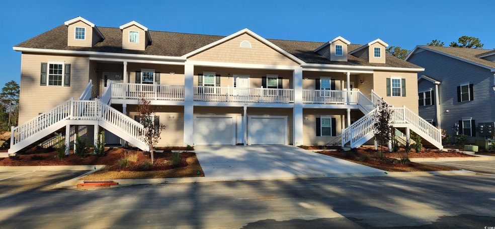 Coastal home featuring a garage, cooling unit, and