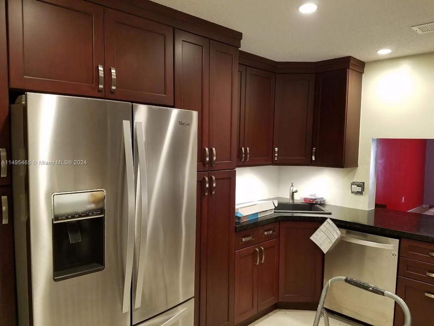 Kitchen features under cabinet lighting and ceiling lighting.