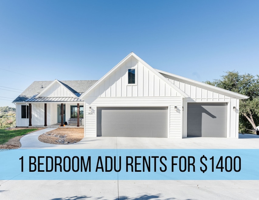 View of front of property with board and batten siding, covered porch, driveway, and a shingled roof