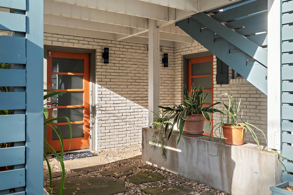 View of exterior entry with brick siding