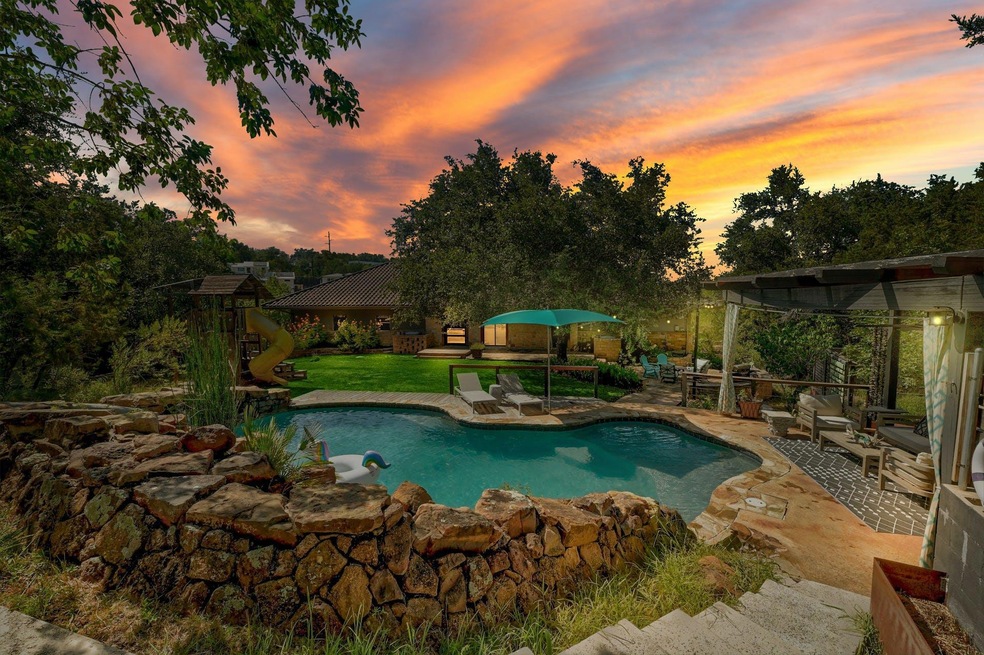 Swimming pool with a patio and a lawn