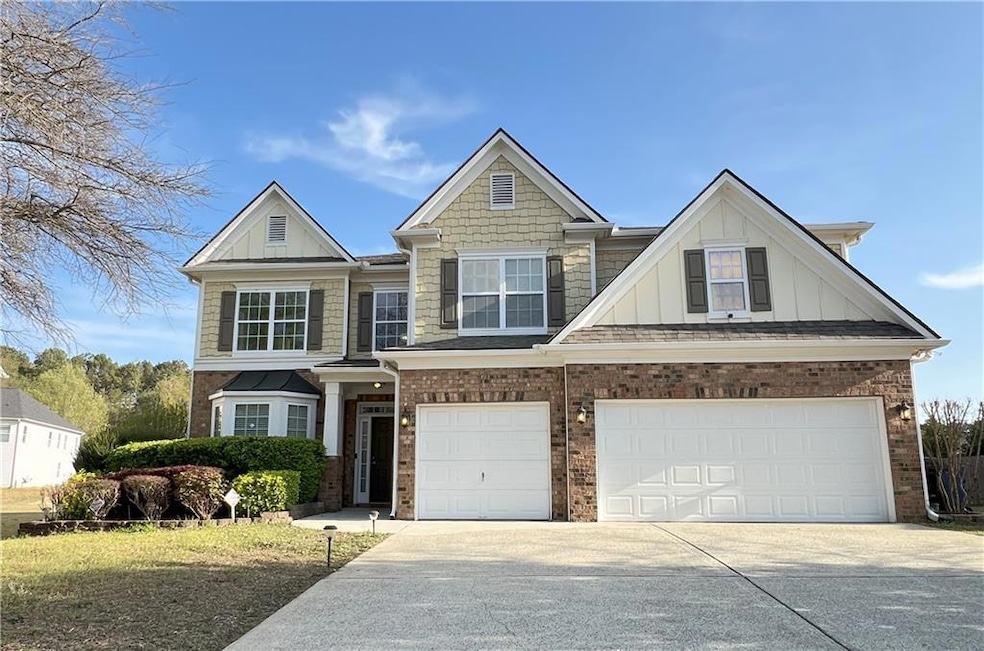 View of front facade with brick siding, driveway, 