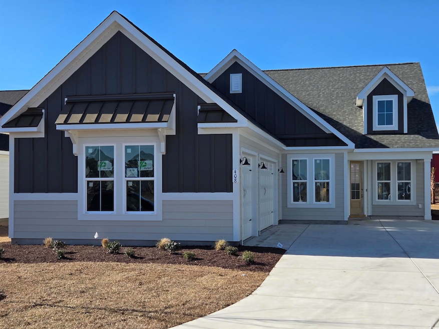 View of front of property featuring a garage, roof