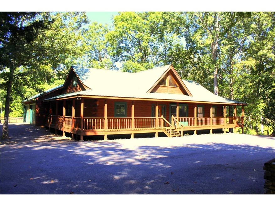 Custom Log Home with complete wrap around porch
