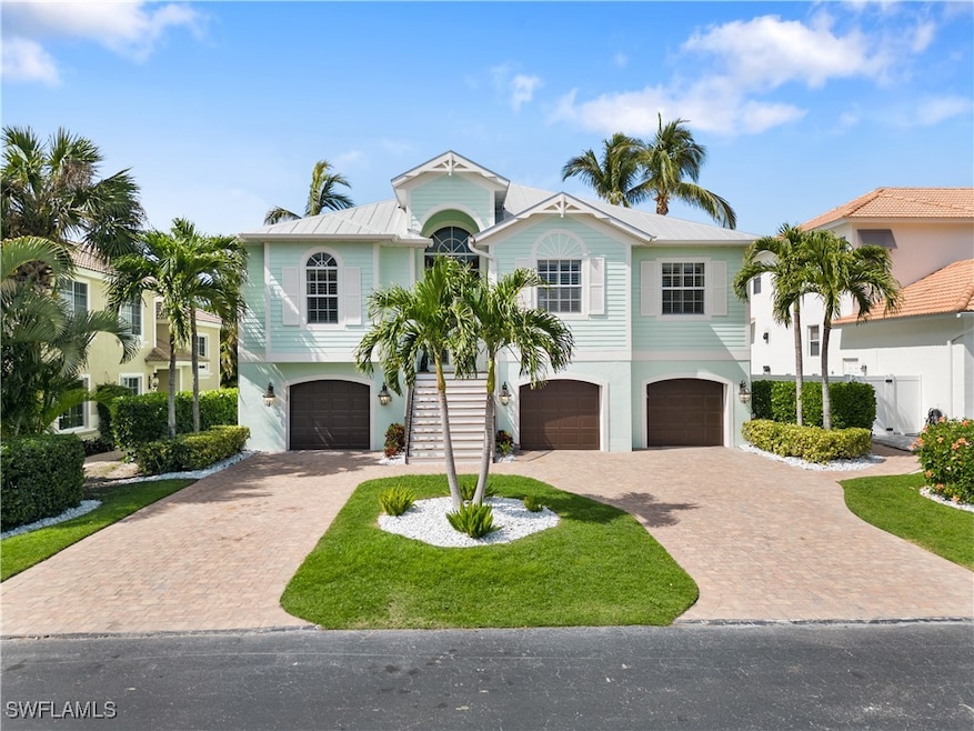View of front of home with a front yard and a gara