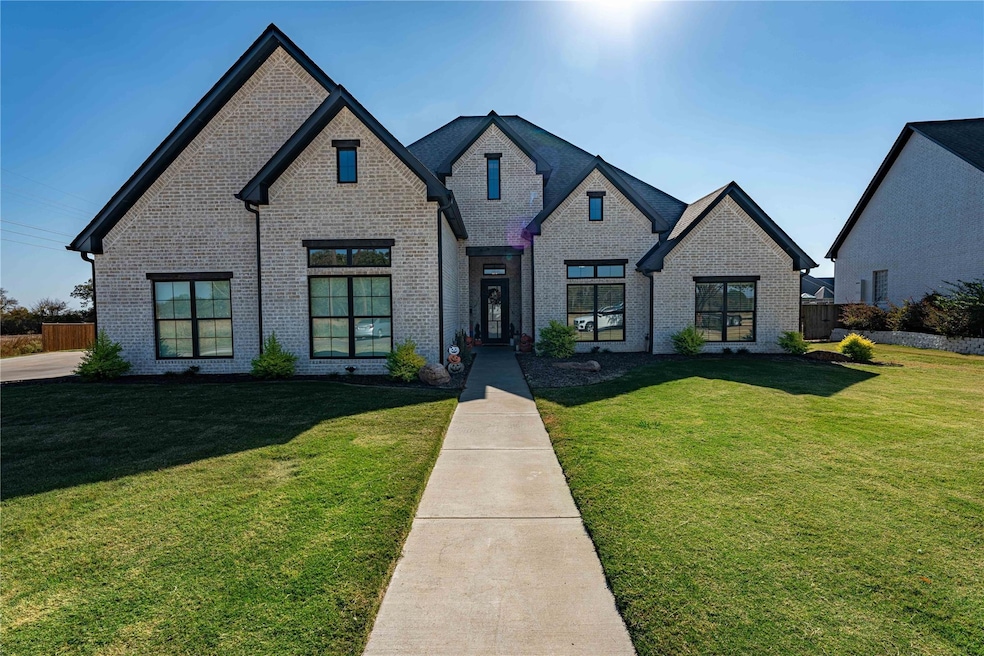 French country style house featuring a front yard