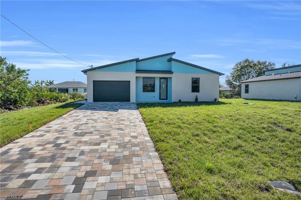 View of front of home with a garage and a front la
