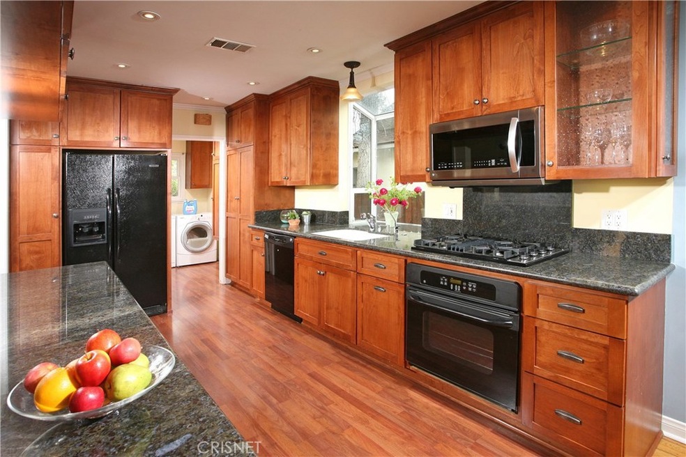 The chef in the family  is going to truly appreciate the remodeled kitchens recessed lighting, crown molding, large garden window, custom cabinetry with glass insert, pantry with handy pull-outs, built-in waste bin cabinet, granite counter tops with 