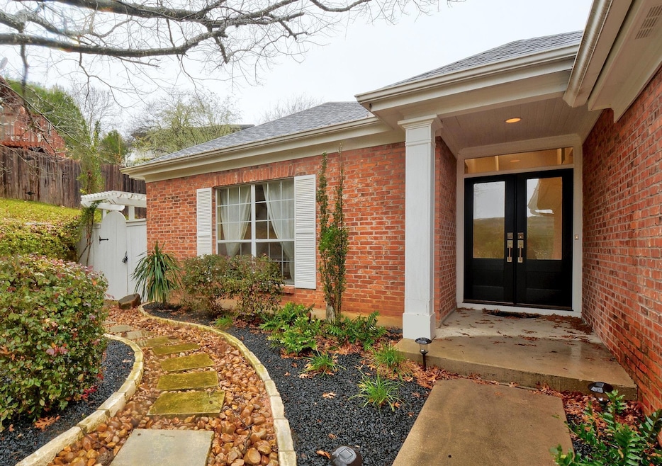 View of exterior entry with french doors, brick s