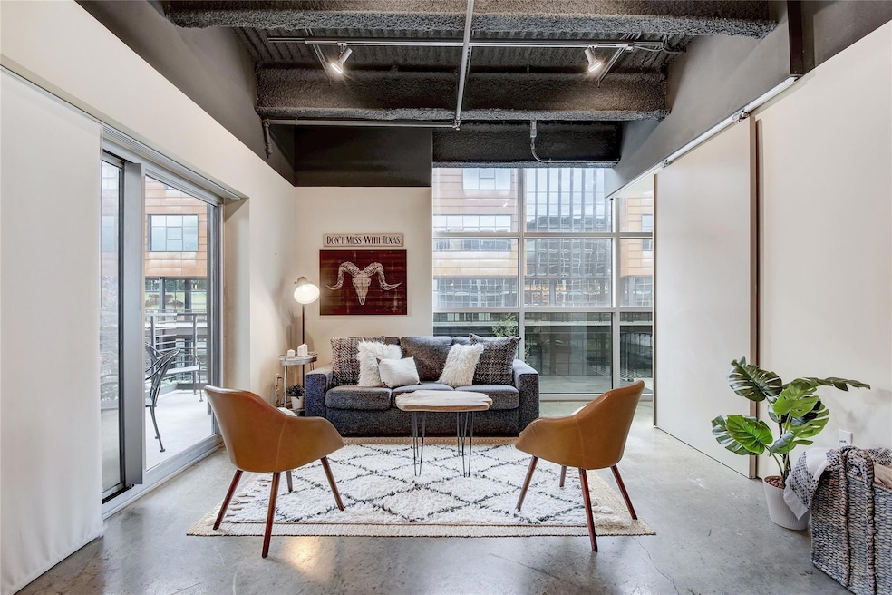 Living room with concrete flooring and rail light