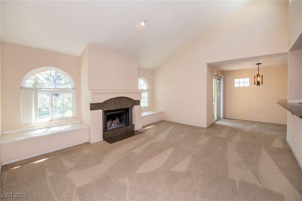 Unfurnished living room with carpet floors, high v