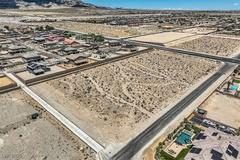 Birds eye view of property with a mountain view and view of desert