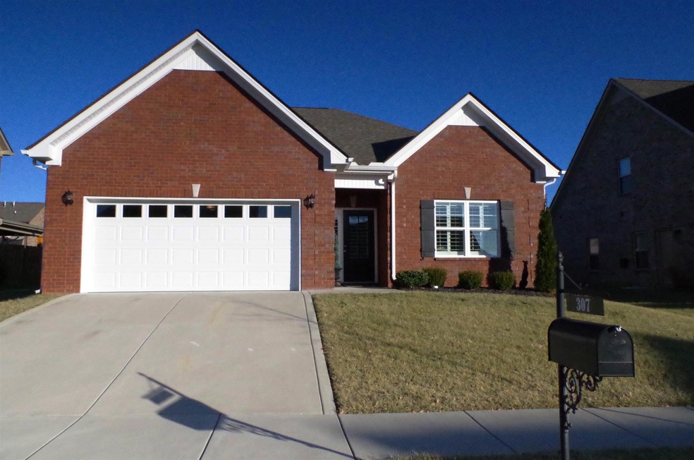 Front elevation of home. 3 sides brick, 2 car garage with openers and covered front porch.