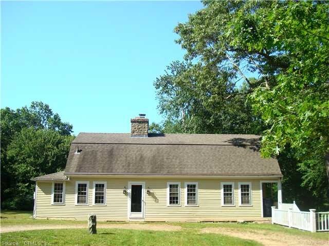 Exterior Front. Antique Gambrel Cape with circular