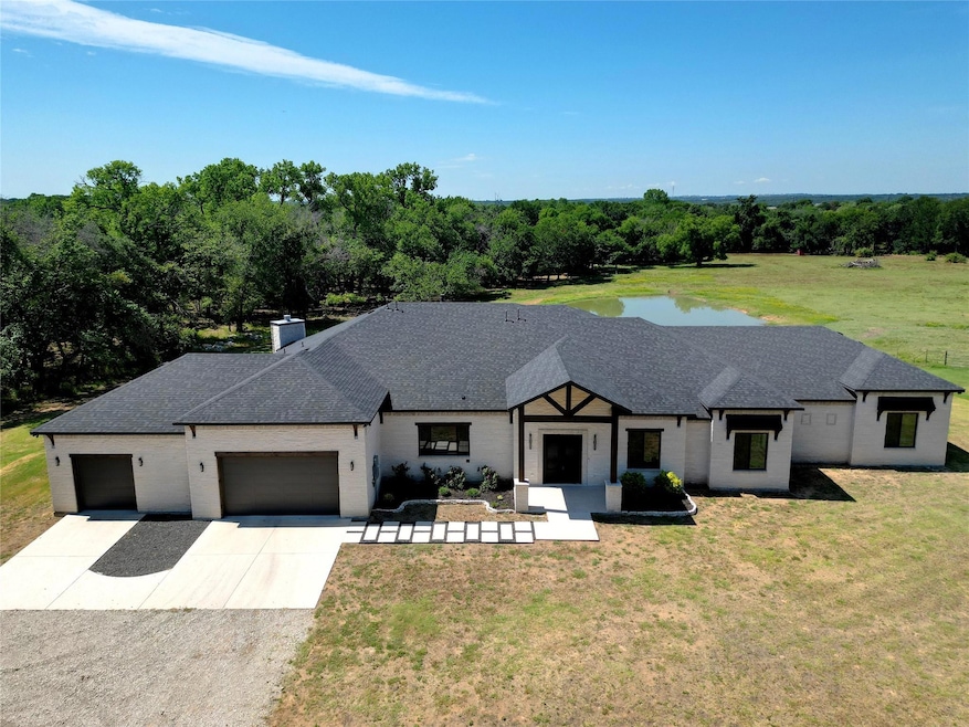 View of front of home with a garage and a front la