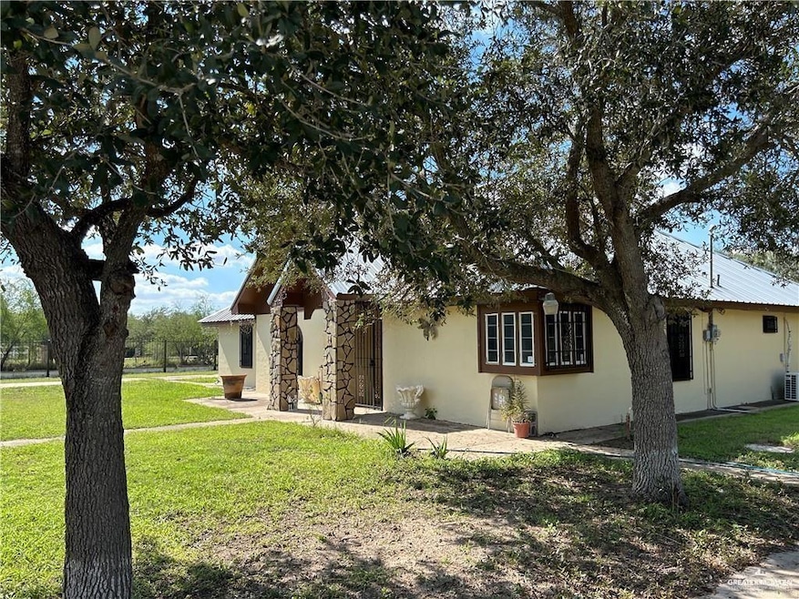 Ranch-style home with stucco siding and a front lawn