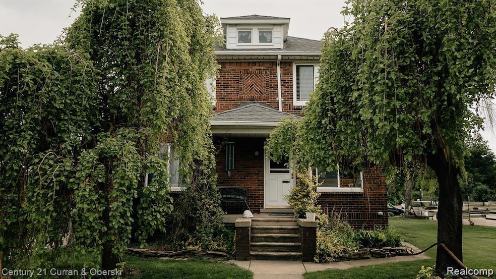 View of front of home with a porch, brick siding, and a shingled roof