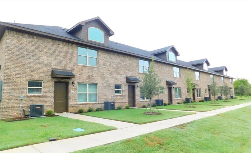 View of front facade with central air condition unit and a front lawn