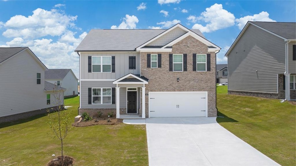 View of front of house with a front lawn and a gar