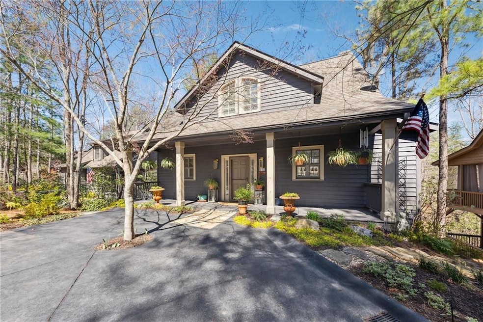 View of front of home with a porch and a shingled roof