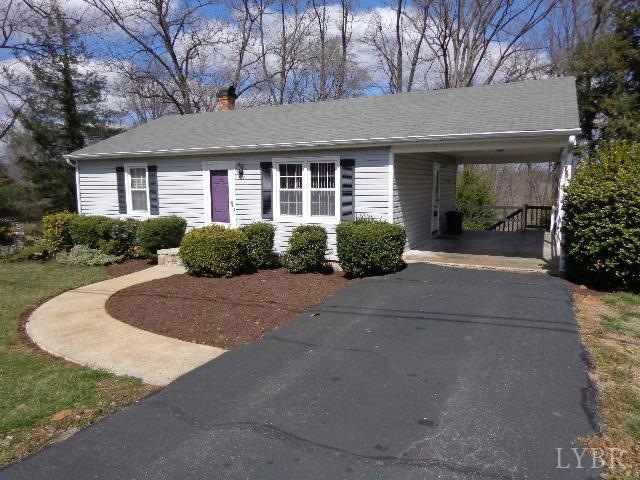 Front of home showing carport with stairs to terrace level deck