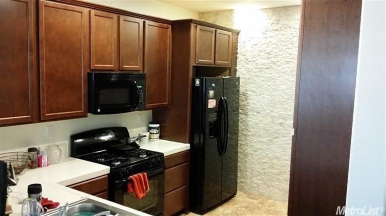 open kitchen and tiled wall separating the convert