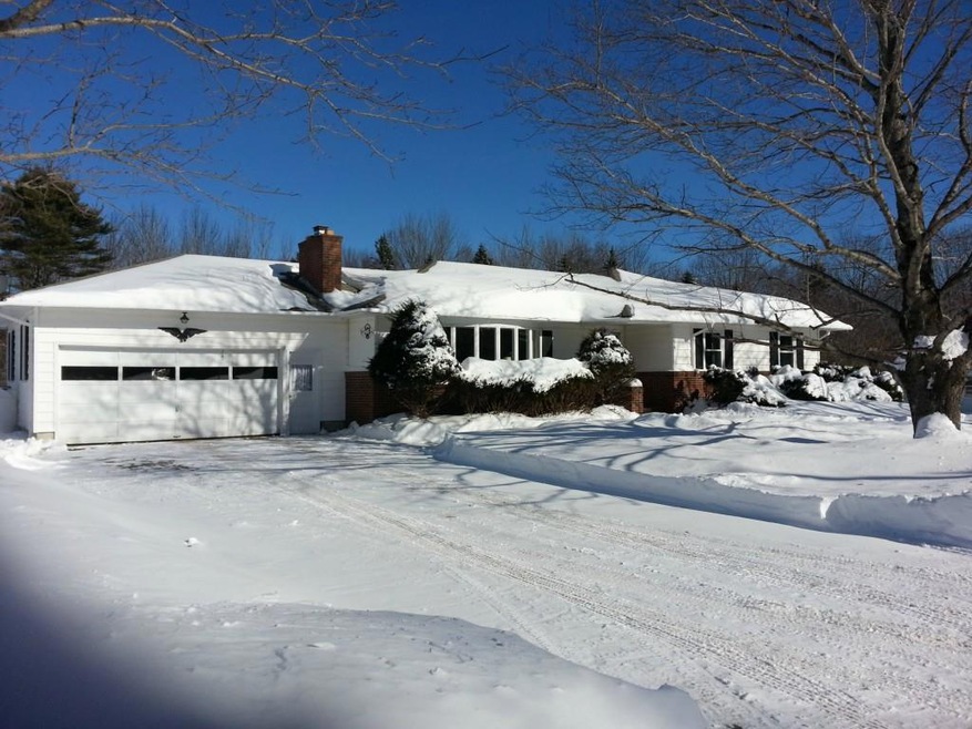 Front of home, deciduous maple trees...
