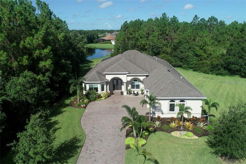 Front aerial, impressive pavered driveway, preserv