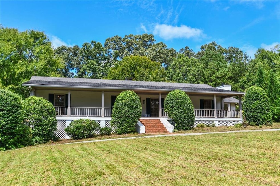 Single story home featuring a porch, a front lawn, and a chimney