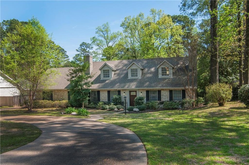 Beautifully landscaped home with a circle drive an