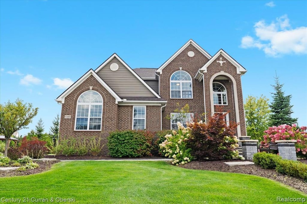 Traditional-style house with a front yard and brick siding