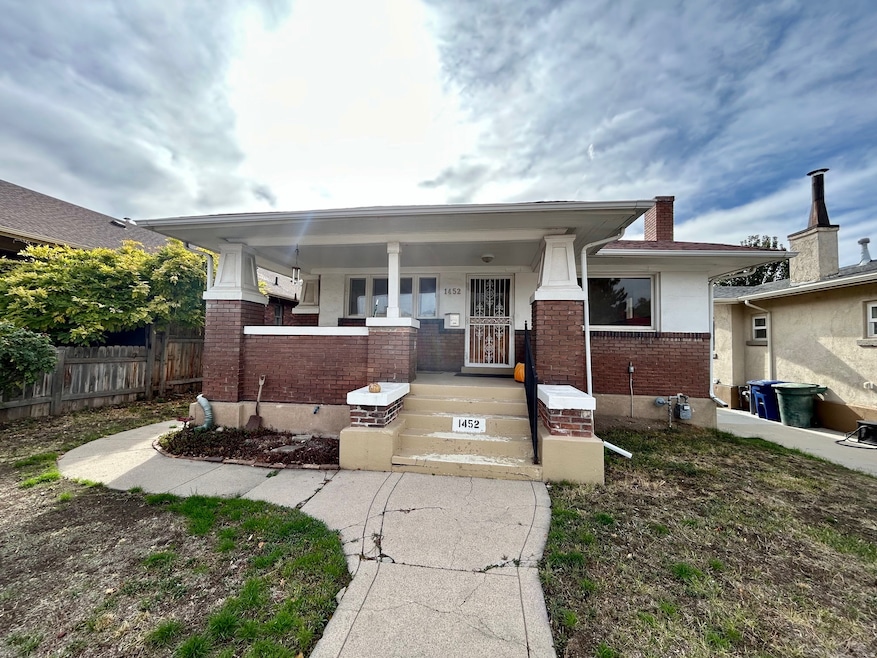 View of front facade featuring a porch and brick siding