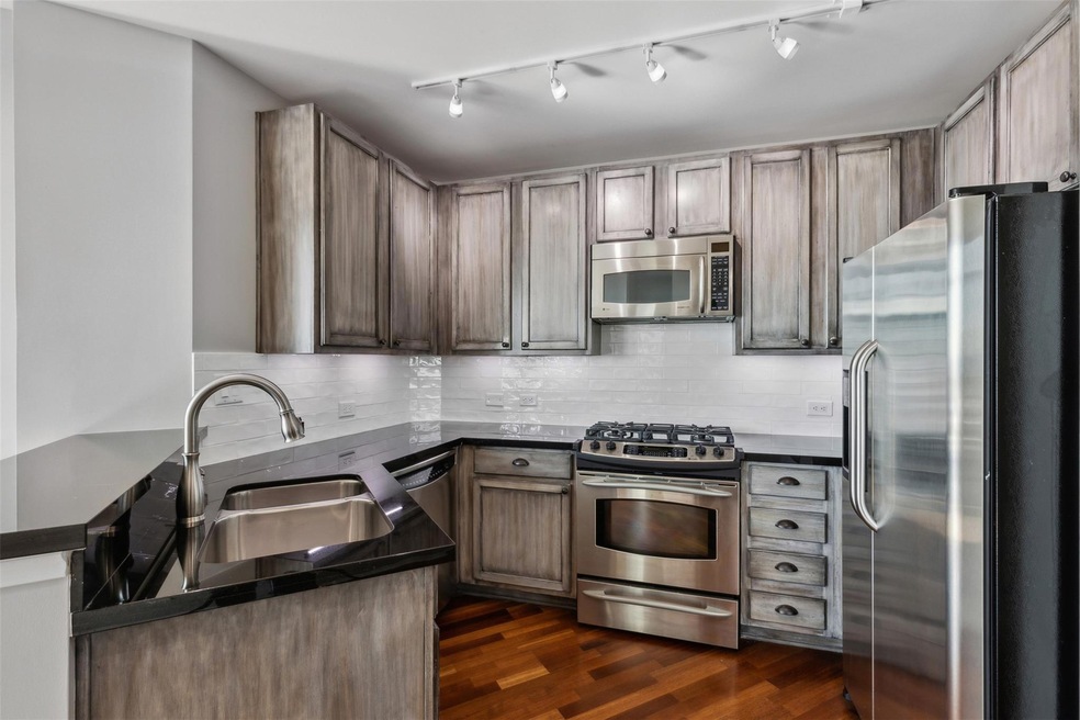 Kitchen featuring kitchen peninsula, dark hardwood