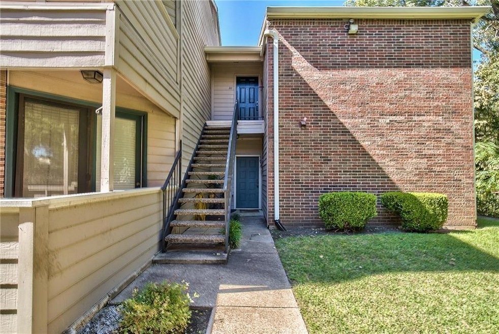 View of exterior entry with a lawn