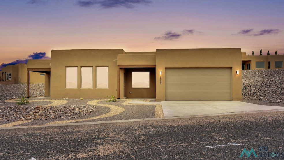 Southwest-style home featuring stucco siding, concrete driveway, and an attached garage