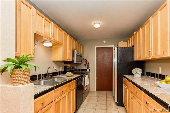 Beautiful alley style kitchen featuring marble cou