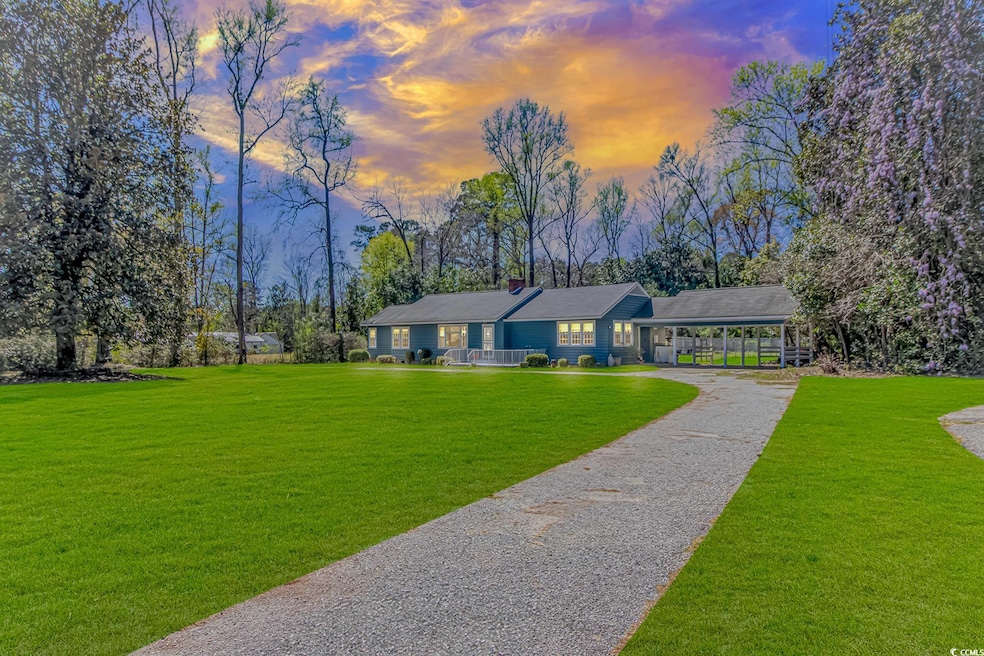 Ranch-style house with a chimney, gravel driveway,